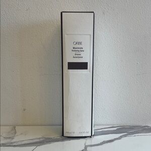 Oribe Maximista Thickening Spray in Elegant White Packaging